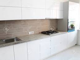 Place a sleek one in a tight corner or along a narrow wall, and show off all your cool dishware in style. White Kitchen Without Handles Interior Design House Stock Photo Picture And Royalty Free Image Image 100402672