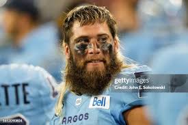 Wynton McManis of the Toronto Argonauts tackles Devonte Williams of... News  Photo