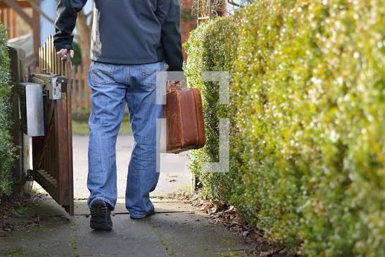 Man leaving home with a suitcase for a journey — Photo — Lightstock