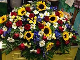 Such arrangements as casket sprays, floral rosaries, casket crosses, or lid arrangements are usually sent by the immediate family, and meant to be displayed on the casket in an intimate memorial. Sunflower Garden Casket Spray In Bedford Va Frederic S Flowers