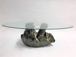 It has an oval glass top, the base is made from plaster. Unique Sculptural Black Bear Coffee Table 1970s 101468