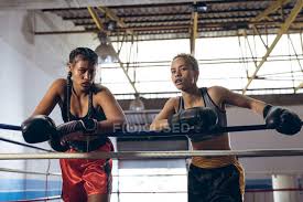 front view of female boxers leaning on