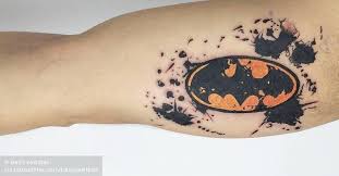 Here, the batman logo has been inked in solid black on one half and completed with the joker's mad laugh on the other. Watercolor Batman Logo Tattoo On The Right Inner Arm
