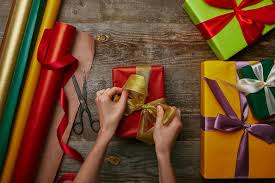 Check spelling or type a new query. Cropped Shot Of Woman Tying Ribbon On Wrapped Christmas Present On Wooden Surface With Other Gifts Free Stock Photo And Image
