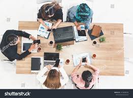 Top View Of Businessman Executive In Group Meeting With Other Businessmen And Businesswomen In Modern Office With In 2020 Stock Photos Business Man Corporate Business
