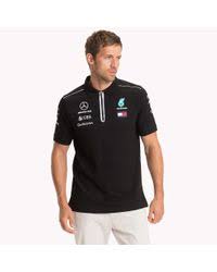 Another american company that specializes in manufacturing products related to fashion, including accessories like watches, eyewear, fragrances, luggage, and footwear. Tommy Hilfiger Cotton Mercedes F1 Team Polo Shirt In Black For Men Lyst