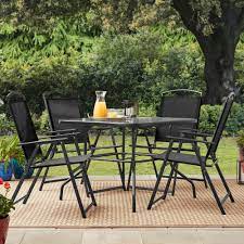 Folding up for easy storage and transport, this set includes four sling chairs and a tempered glass top table crafted of sturdy steel with a powder coated finish to resist corrosion. Mainstays Albany Lane Outdoor Patio 5 Piece Dining Set Black Frame And Sling 4 Person Walmart Com Walmart Com