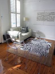 Check these wild zebra print accent chairs. White Living Room With Zebra Rug And Ghost Chairs Hgtv