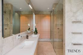 Walls painted white or a light color make a room feel larger. This Long Narrow Bathroom Has The Gallery 3 Trends