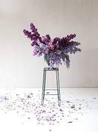 Whimsical Purple Arrangement With Lilacs And Wisteria Anne Van Midden Lilacs Spring In 2021 Purple Flower Arrangements Purple Flowers Wedding Flower Design