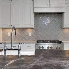 Since the lines tend to be cleaner than something that is super traditional, you can add. White Raised Panel Kitchen Cabinets With Gray Geometric Tile Backsplash Transition Trendy Kitchen Backsplash Kitchen Tiles Backsplash Gray Kitchen Backsplash