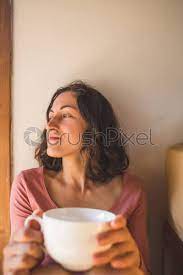 But what do you do in the afternoons? Woman Drinking Coffee In The Morning By The Window Overlooking Stock Photo Crushpixel