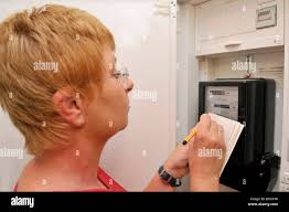 Woman reading energy meter hi-res stock photography and images