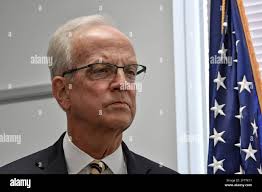 Emporia, Kansas, USA, April 8, 2021 Under the watchful eye of Emporia  Police deputy chief Kevin Risley members of the Westboro Baptist Church  display their well known hate signs outside the Emporia
