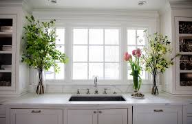 Low And Large Window Over Sink Glass Door Cabinetry On Sides Of Windows Reflects The Light And D Home Kitchens Marble Countertops Kitchen Kitchen Inspirations