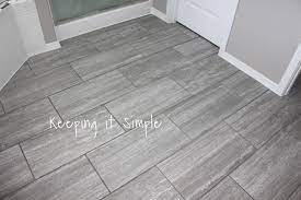 Gray tile bathroom floor with glass tile bathroom wall. Pin On New Home