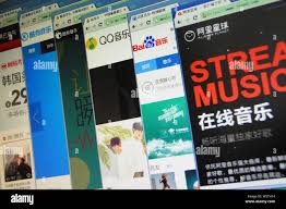 FILE--A Chinese netizen browses the websites of (from left) Chinese online  music sites Kugou.com, Kuwo.cn, QQ Music of Tencent, Baidu music, and Ali  Stock Photo - Alamy