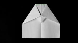 Make a diagonal fold in the middle of the paper (along the dashed lines, if you're using the glider template) so that the corners of your paper are offset and make two peaks. Bullnose Glider Paper Plane Depot