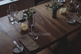 The arrangement of tables and seating charts near them have great value in many premises and situations. High Angle View Of Table Arrangement And Decoration At Cafe Glass Top Stock Photo 225304360