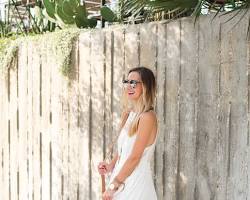 Image of woman wearing a flowy dress, boho accessories, and comfortable shoes at a Texas festival