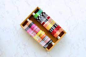 2) next, place the strips of tape on the tissue paper or napkins with the sticky side down. How To Make A Washi Tape Dispenser How Tos Diy