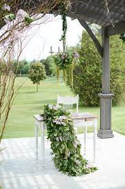 Outdoor Garden Inspired Wedding With Greenery Dripped Chandelier Curly Willow And Lavendar Filled Floral Runner Perg Outdoor Garden Pergola Garden Inspired