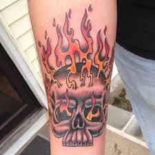 Traditionally depicted in tattoo art as an anatomical skull embellished by flames, from there the many themes and styles vary according to personal taste. Flaming Skull Old School Tattoo On Forearm