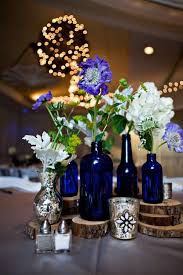 These Blue Glass Bottles And Wooden Centerpieces Gave Jon And Lindsay S Wedding An Eleg Blue Wedding Decorations Blue Wedding Centerpieces Cobalt Blue Weddings