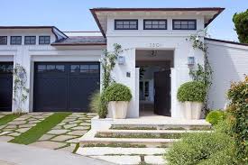 White Brick Home With Black Garage Doors Cottage Home Exterior Cottage House Exterior White Stucco House Garage Door Design