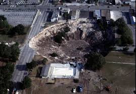 sinkhole swallows house, five porsches
