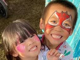 Mitchell and Hazel Nguyen skip happily down the road hand in hand