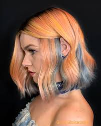 Portrait of a young blond woman with colourful streaks in the hair and a big sweet multicolored lollipop in her hands squinting and having fun. 20 Pretty Peekaboo Highlights You Need To See Now
