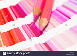 red and pink colored pencils and color chart of all colors