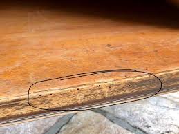 What are local USA recommendations for treating woodworm damage in furniture ?