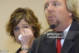 Eva Rowe wipes her eye as her attorney Brent Coon, right, speaks in... News  Photo