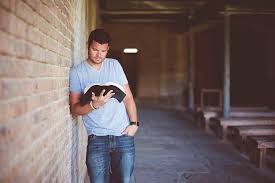 This photo is about technology, urban, wall. Hd Wallpaper A Man Leaning Against A Wall Outside While Reading A Book One Person Wallpaper Flare