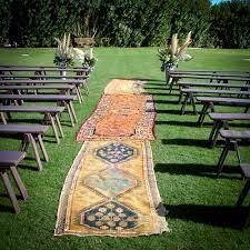 The best thing about using a rug in your ceremony is that it's a decoration you'll reuse for years to come. Persian Rugs As The Aisle For Outdoor Wedding Ceremony Johnny Was Clothing The Faerie Tale Weddin Diy Wedding Aisle Runner Aisle Runner Wedding Wedding Aisle