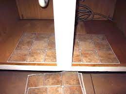 Is there any easy way to replace/repair this without having to tear out the old bottom and replace it with a new one? How To Fix A Warped Cabinet Floor Wood Repair Under Kitchen Sink Diy Kitchen Storage