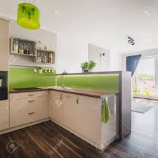 Chant plan travail stratifié effet travertin beige mat l.500 l.4.5 cm, ep.0.6 mm. Stylish Kitchen With Beige Furniture And Bright Green Decorations Stock Photo Picture And Royalty Free Image Image 59566629