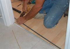 Ceramic tile to laminate floor transition. How To Install A T Mold Transition Between Laminate Ceramic Tile Construction Repair Wonderhowto
