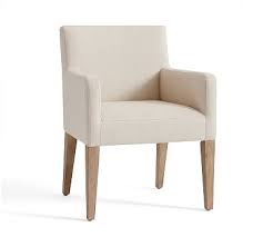 In a stark white room with a partially slanted ceiling, contrast is injected by way of a dark smoked glass dining table and deep blue. Pb Classic Dining Chairarm Chaironelinenseadrift In 2020 Upholstered Dining Side Chair Dining Room Chair Cushions Velvet Dining Chairs