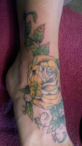 Butterfly and lily flower tattoo on foot. Yellow Rose Traditional Tattoo On Foot And Ankle