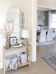 Pretty Spring Entry Features Wood Console Table And Arched Mirror Dining Room With Beaded Chandelier And W Entryway Table Decor White Console Table Home Decor
