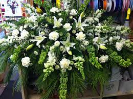 Casket Spray With Bells Of Ireland Snapdragons Lilies Carnations Button Pom Etc Pauline S Blo Funeral Flower Arrangements Funeral Floral Casket Flowers