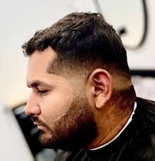 This is a shadow mid drop fade with a messy fringe/french crop style cut.  This haircut can also be done with a low fade, burst fade, and other styles  too.