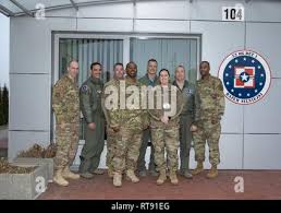 Lask Air Base, Poland -- Master Sgt. Kevin Winter, South Dakota Air  National Guard 114th Aircraft Maintenance Squadron crew chief, directs an  F-16 Fighting Falcon to its parking spot as it arrives