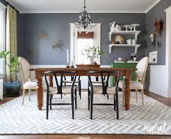 A glamorous dining room set up with an elegant red rug covering the tiles flooring. 5 Ways To Upgrade Your Dining Room In 2020