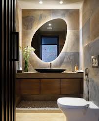 Attic bathroom with sloped bathroom mirror ideas and marble vanity. 10 Spectacular Ideas For Backlit Bathroom Mirrors