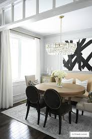 Gray dining room with wooden dining table complementing the buffet tables with striped chairs and a candle chandelier. Dining Room Makeover Reveal New Gray Paint Moldings