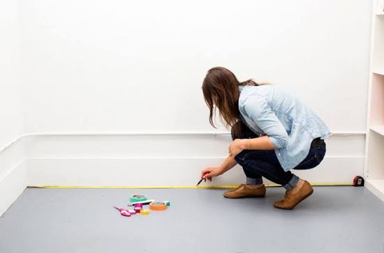 Customer measuring a room before buying furniture in Mauritius
